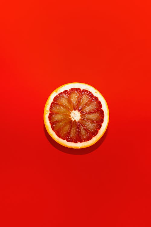 Grapefruit Slice on Red Background