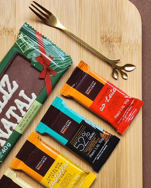 Free An overhead view of various chocolate bars displayed on a wooden board, perfect for food lovers. Stock Photo
