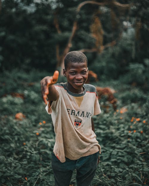 A Boy with His Hand Out