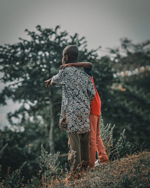 Two Boys Standing Together Outdoors