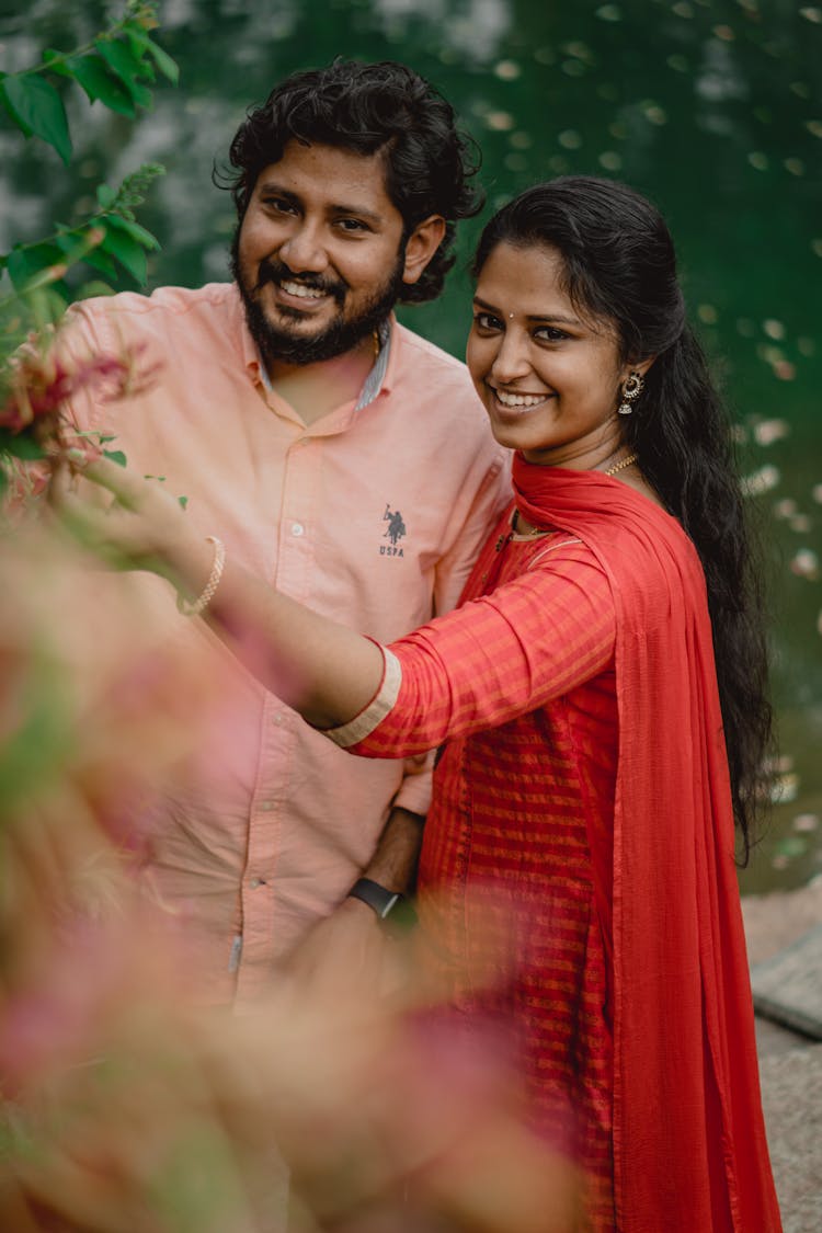 Smiling Man In Shirt And Woman In Traditional Clothing