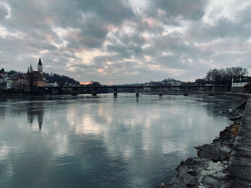 Cloudy Sky Over a Bridge Stretching over a River