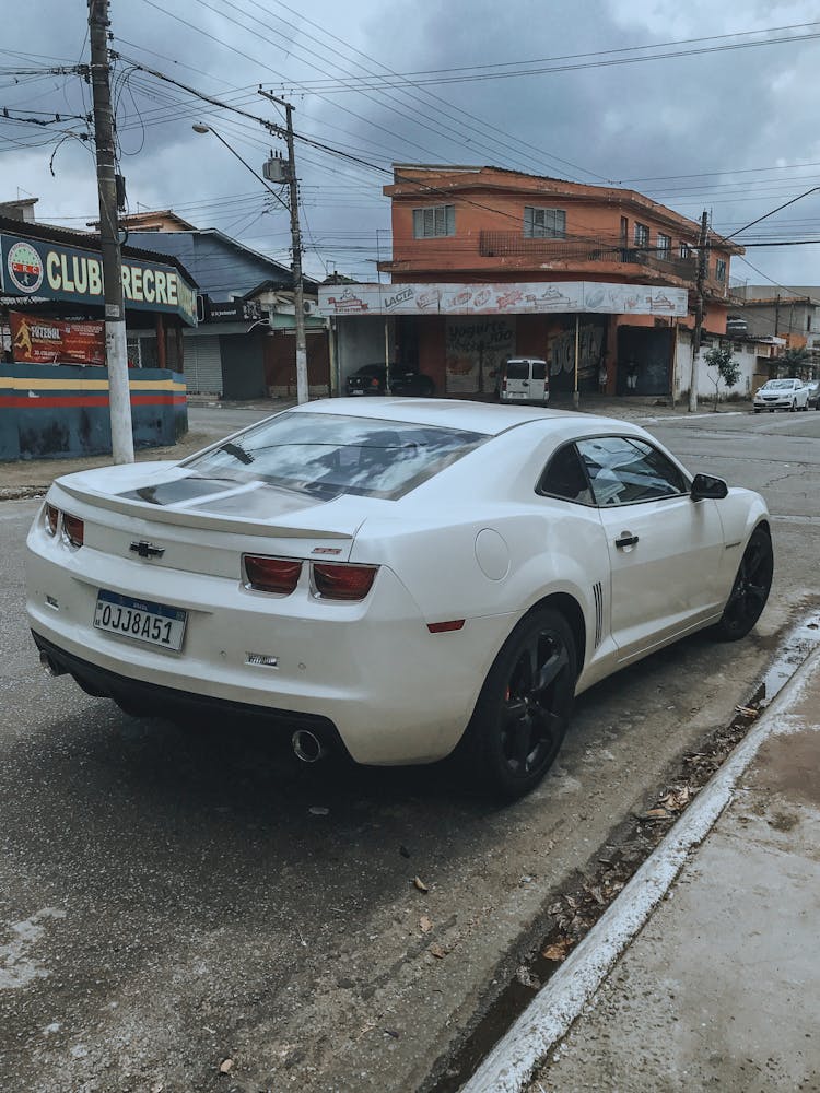 White Chevrolet Car Parked On Road 