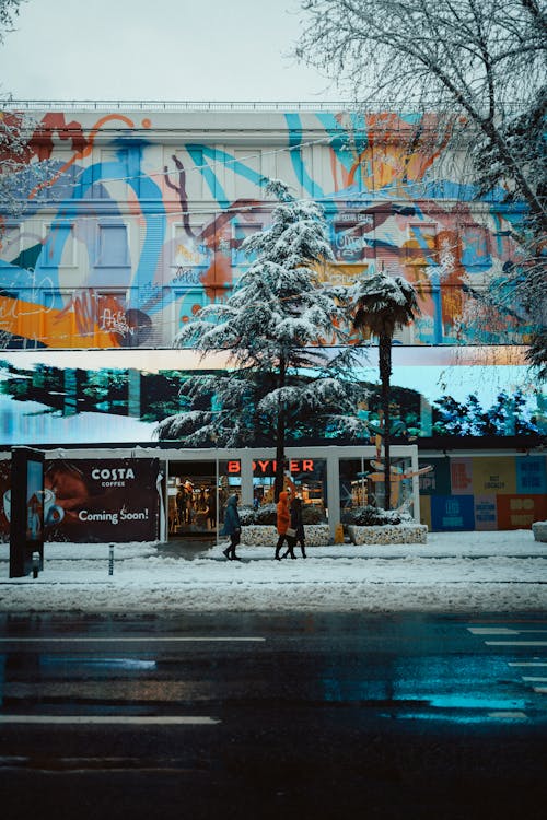 Snow-Covered Sidewalk with a Store in the Background