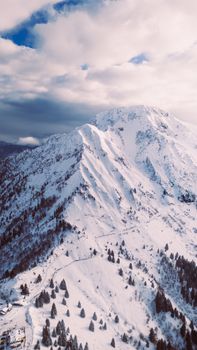Aerial view of the snow-capped mountains at Giogo del Maniva, capturing winter's serene beauty.