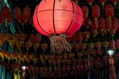 Vibrant red Chinese lanterns illuminate a London street, showcasing traditional culture in an urban setting.