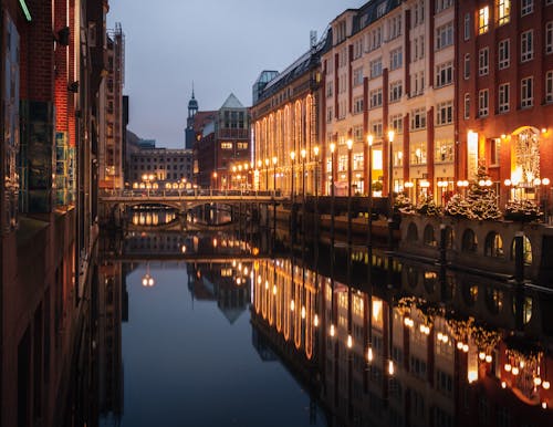 A city with buildings and a canal at night