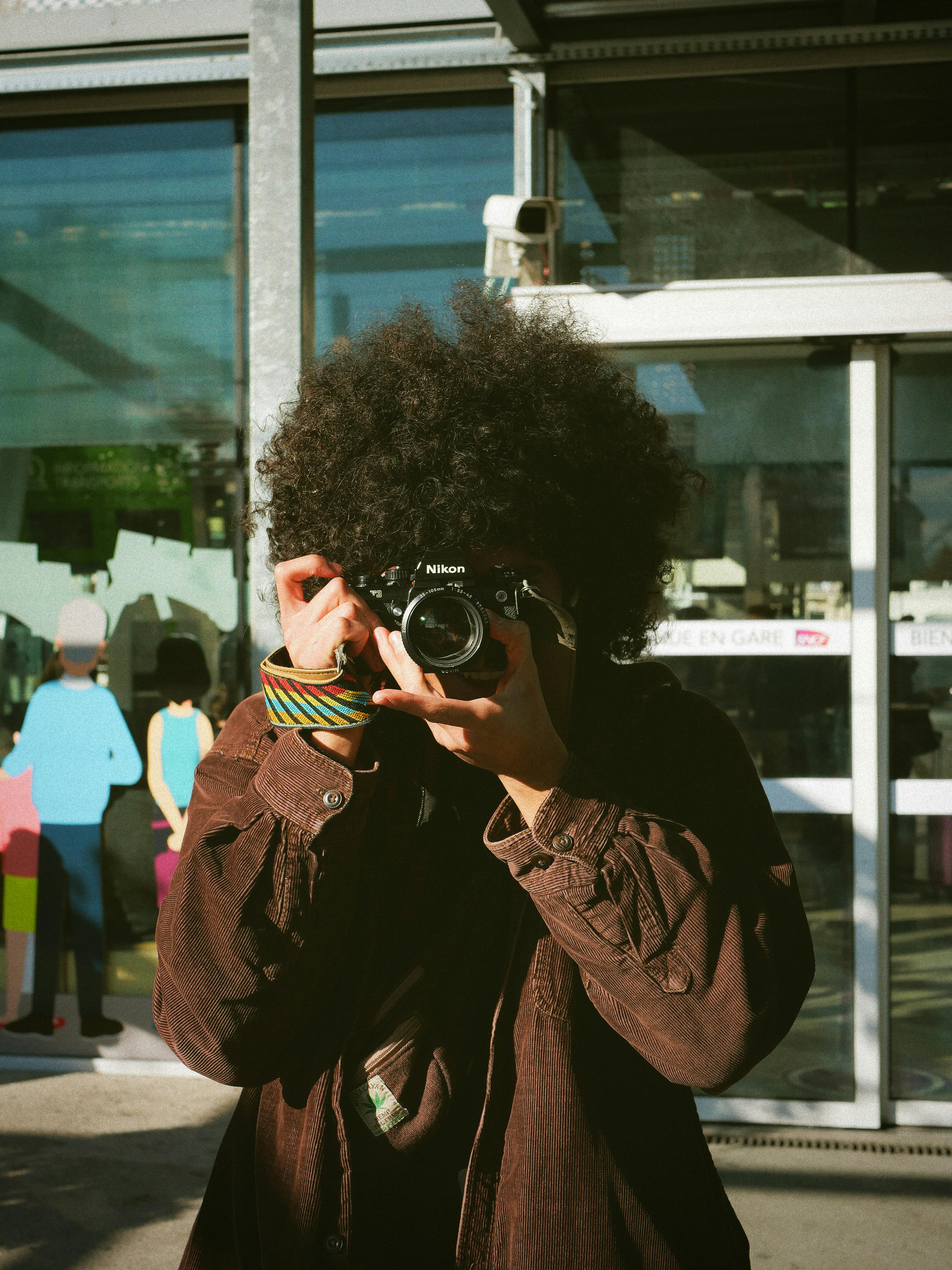 A street photographer takes a shot outdoors in Montpellier, France.