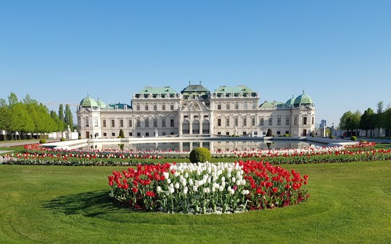 Stunning view of Belvedere Palace with vibrant red and white tulips in Vienna, Austria.