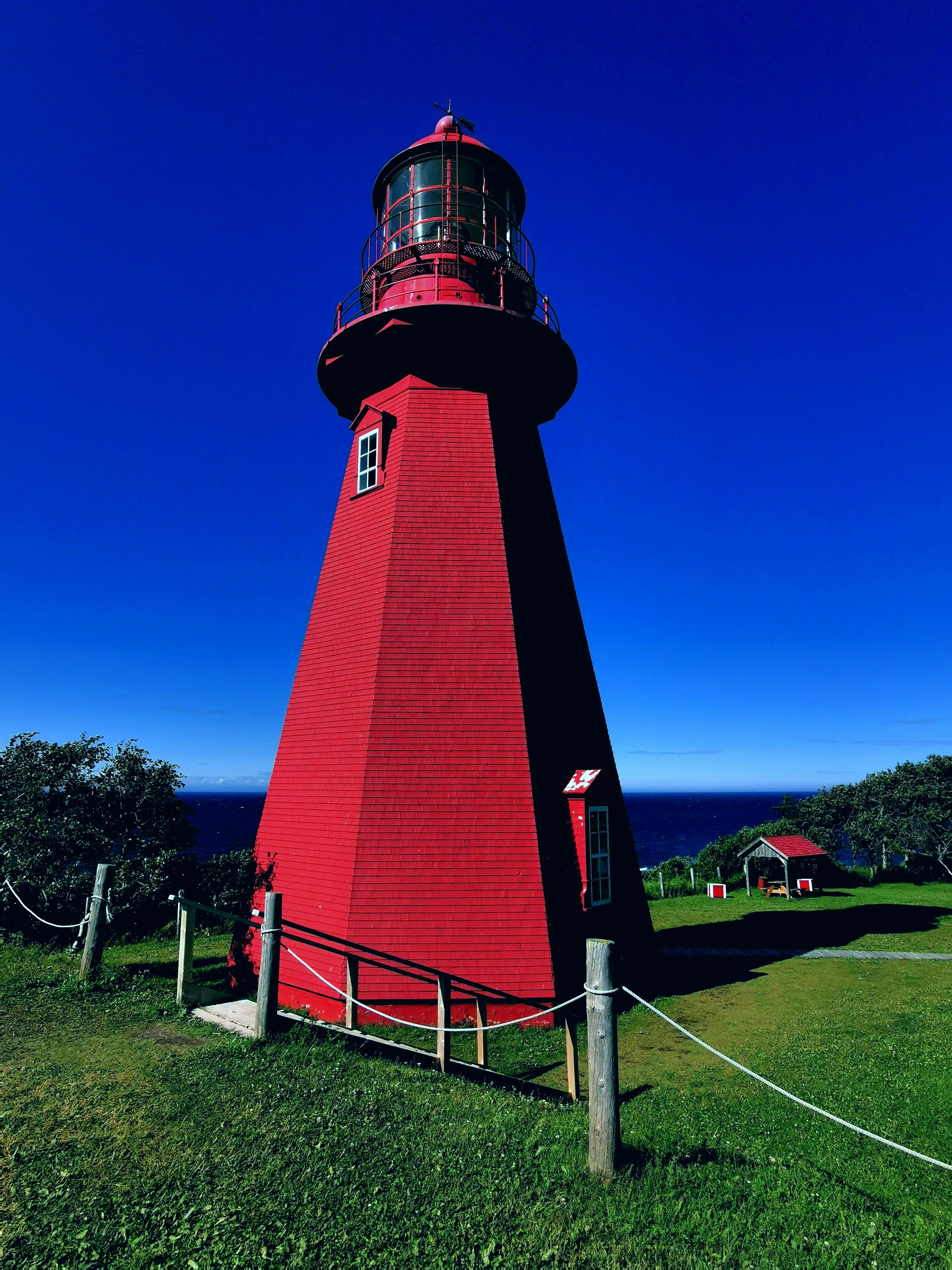 White and Blue Lighthouse under Blue Sky · Free Stock Photo