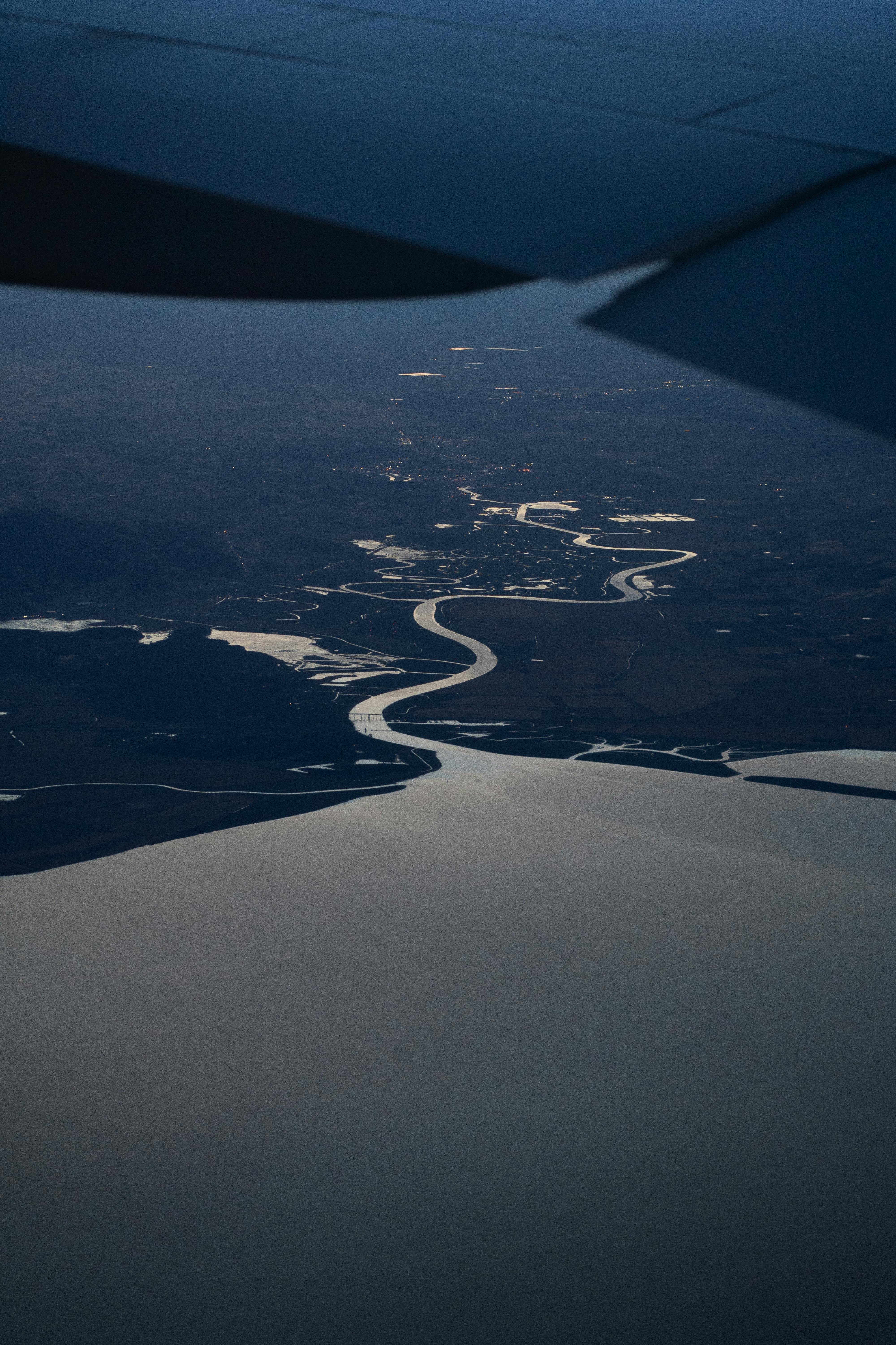Stunning aerial view of winding river meeting the ocean at twilight near San Francisco.