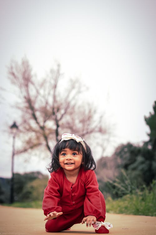 Free Photo of a Smiling Child in a Red Outfit Stock Photo