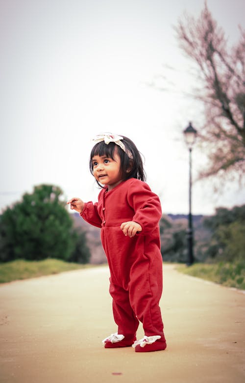 Photo of a Cute Child in a Red Outfit