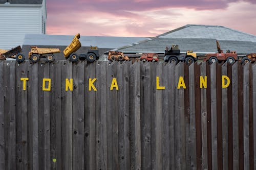 Toys Cars and Trucks on Fence
