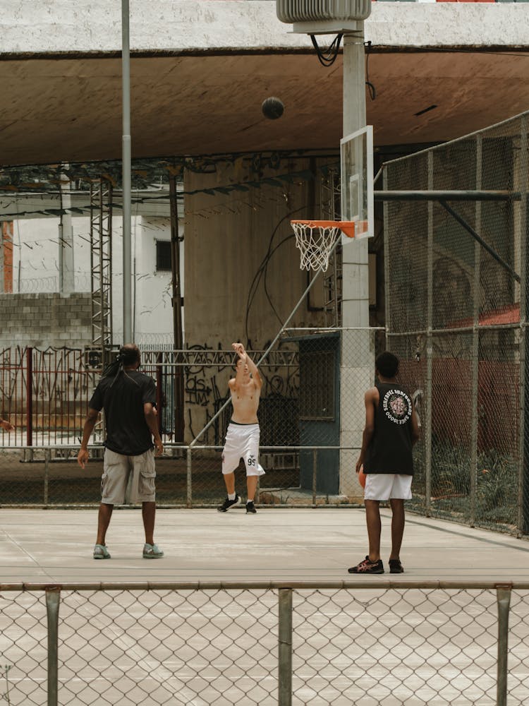 A Group Of Men Playing Basketball