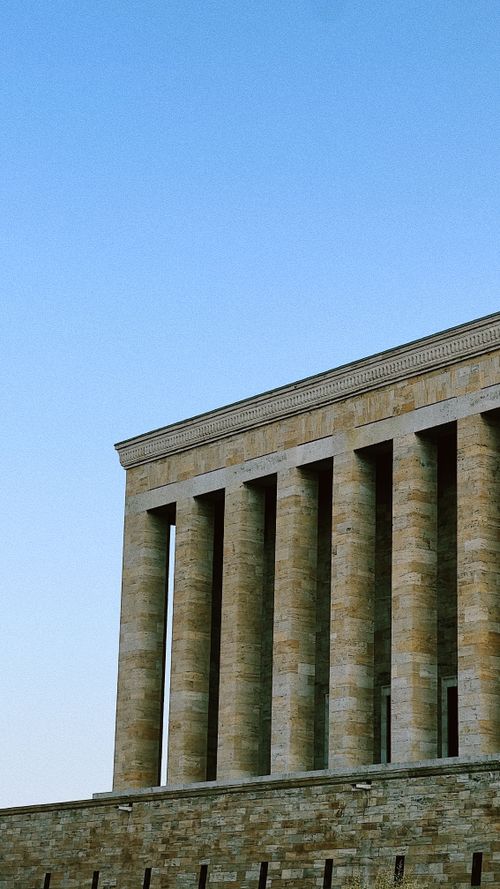 Free Vertical shot of Anıtkabir monument's facade and pillars under a clear blue sky in Turkey. Stock Photo