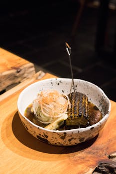 Close-up of a beautifully presented grilled corn dish in a rustic bowl on a wooden table.
