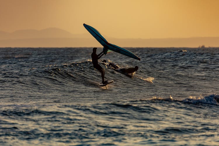 Silhouette Of A Person Kitesurfing