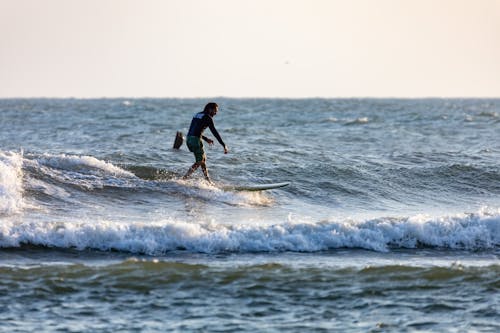 A Man using Surfboard on the Sea