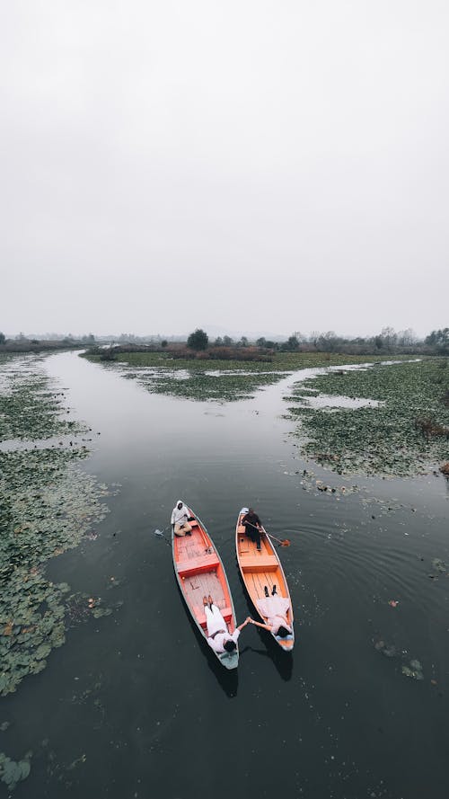 People in Canoes on a River 