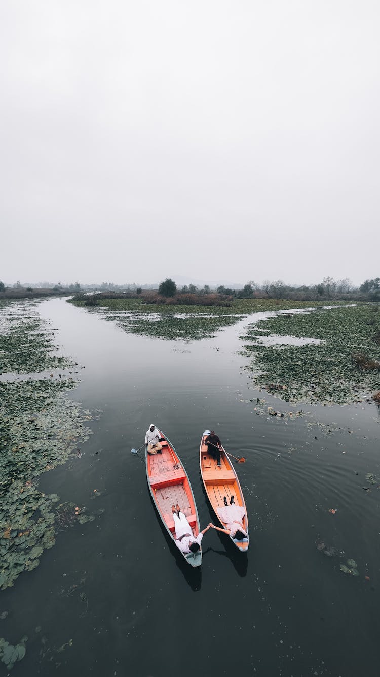 People In Canoes On A River 