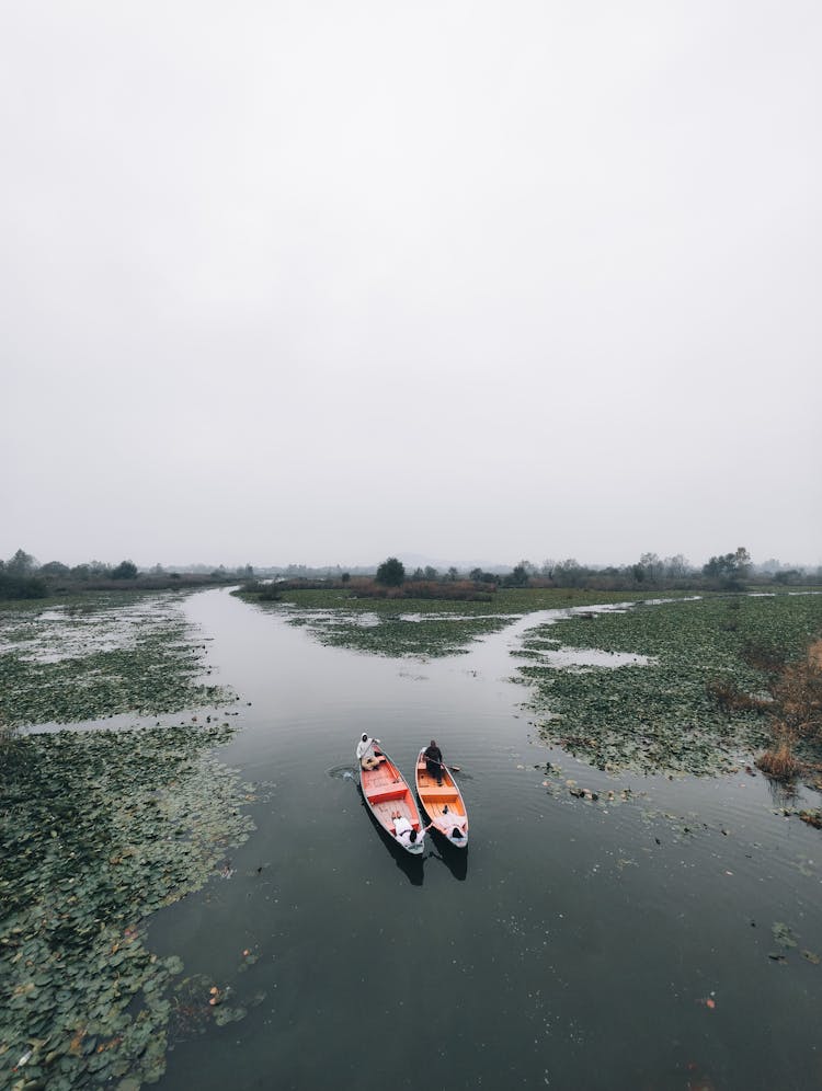 People In Canoes On A River 