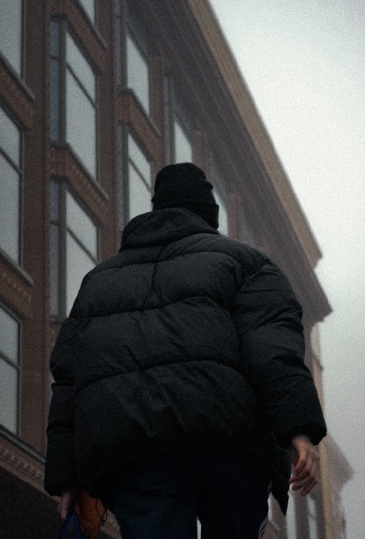 Low Angle Shot Of Person In Black Puffer Jacket 