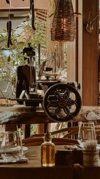 Vintage meat slicer in a rustic cafe setting with warm lighting and earthy decor.