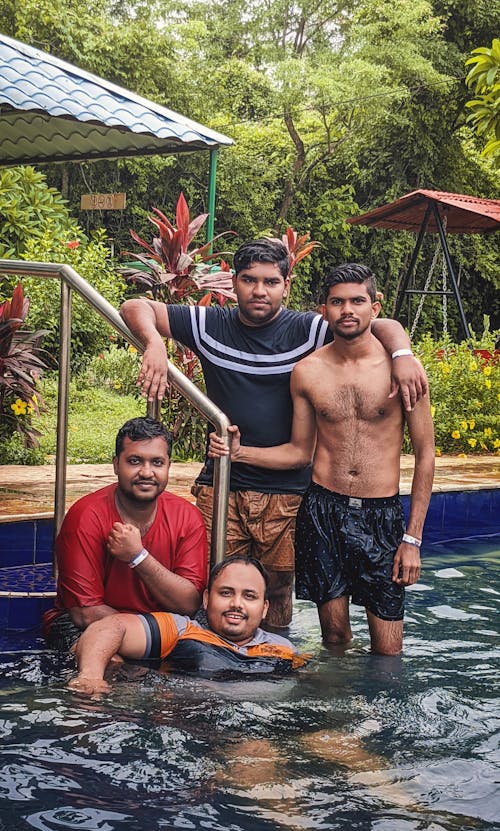 Group Of Friends Enjoying In Swimming Pool