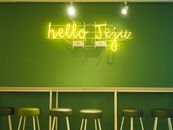 Chic interior with neon 'hello Jeju' sign and green stools against a matching wall.