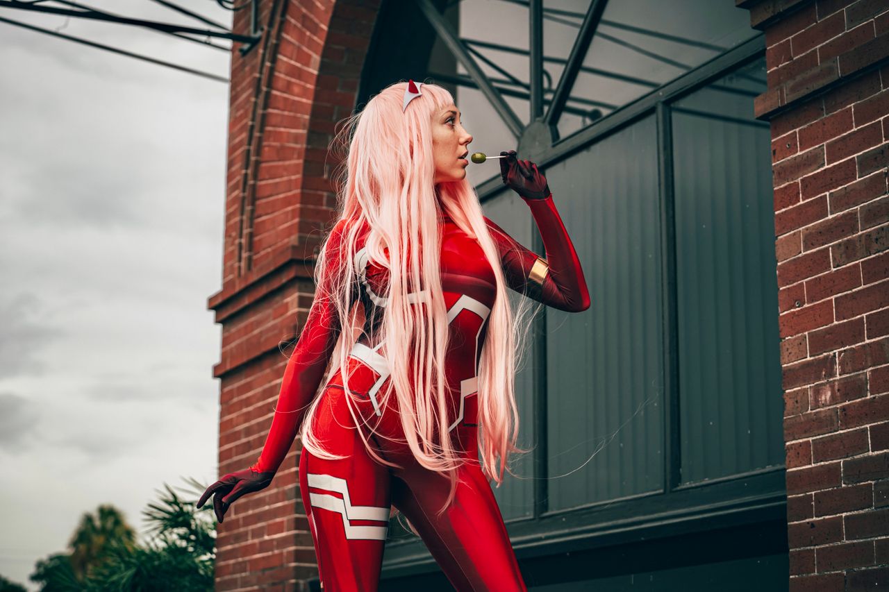 striking portrait of a woman cosplaying in a red costume with long hai