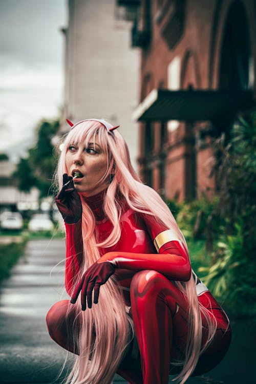 Squatting Woman in Red Cosplay Costume
