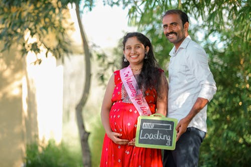 Pregnant Woman and Man Holding Chalk Board