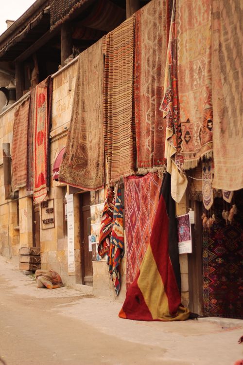 Free Vibrant handmade carpets hanging on a traditional street wall, exuding cultural charm. Stock Photo