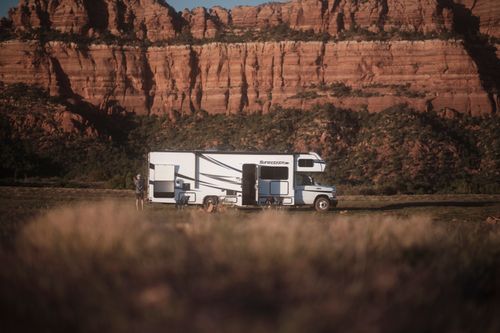 Free RV parked near Utah canyon under clear sky, perfect for adventure and travel enthusiasts. Stock Photo