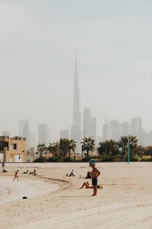 Free People on the Beach with Burj Khalifa on Background  Stock Photo