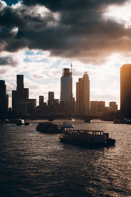 Sea Coast with Skyscrapers and Vessels in City at Sunset