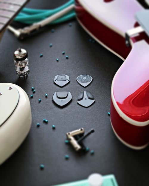 Free Artistic close-up of an electric guitar and plectrums with a modern composition on a dark background. Stock Photo