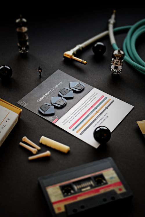 Free A variety of music accessories including guitar picks, a cassette, and cables. Stock Photo