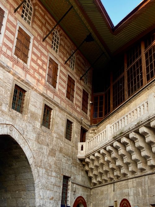 Free An elegant view of a historic castle's architectural facade showcasing intricate masonry and design. Stock Photo