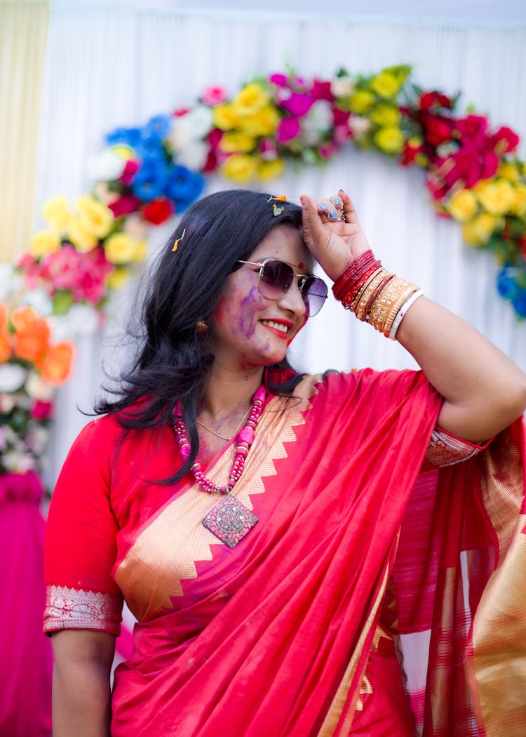 A Smiling Woman Wearing Red Saree