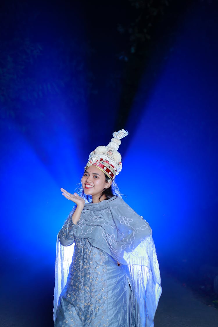 Woman In A Crown And Blue Tunic Illuminated With Blue Light