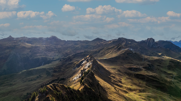 Scenic aerial view of the mountainous landscape in Flums, Switzerland under a cloudy sky.