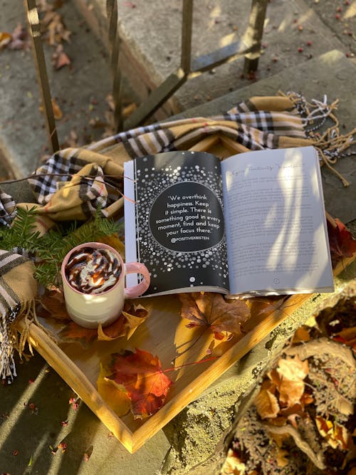 Sweet Coffee and Book among Autumn Leaves