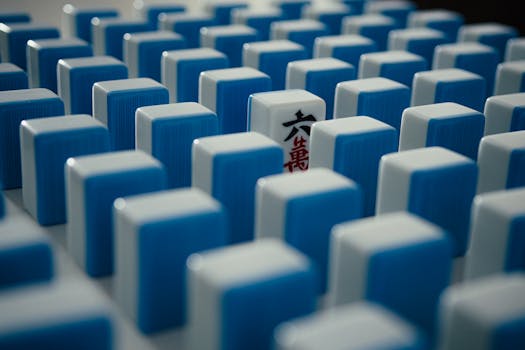 Close-up of a pattern of blue and white Mahjong tiles arranged creatively.