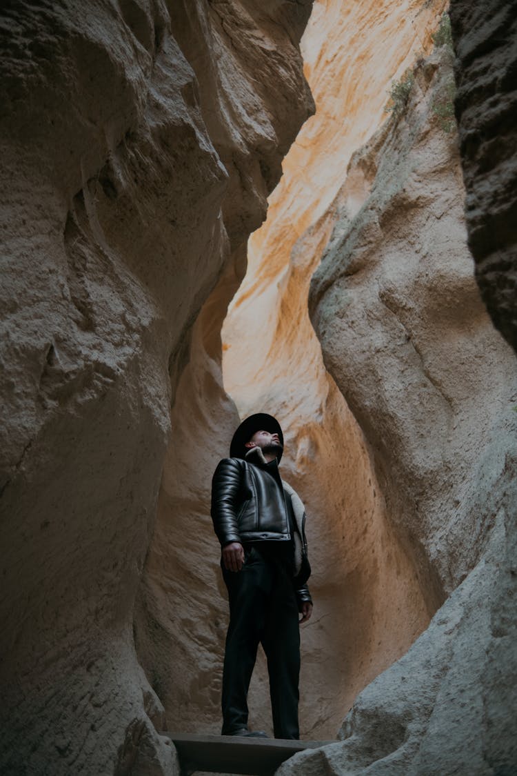 Man In Hat Standing In Canyon