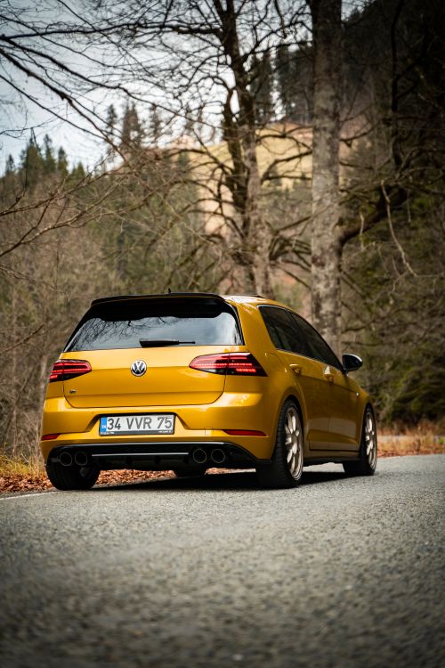 Free A yellow Volkswagen sports car parked on a forest road in Trabzon, Turkey. Stock Photo