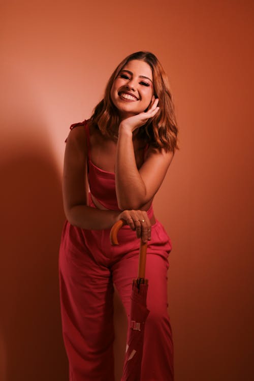 Studio Shot of a Young Woman in a Red Jumpsuit