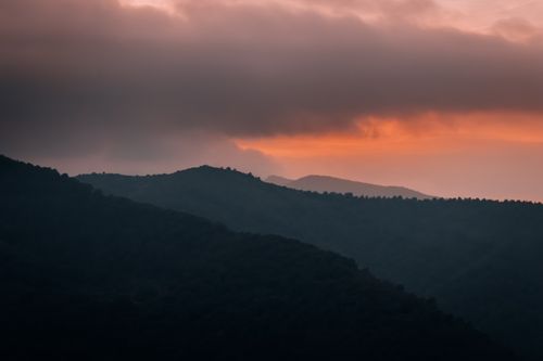 Free A breathtaking view of mountains silhouetted against a vibrant sunset in İzmir, Turkey. Stock Photo