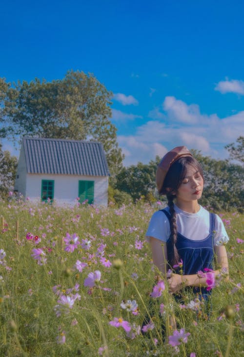 A Young Woman Standing in a Flower Field